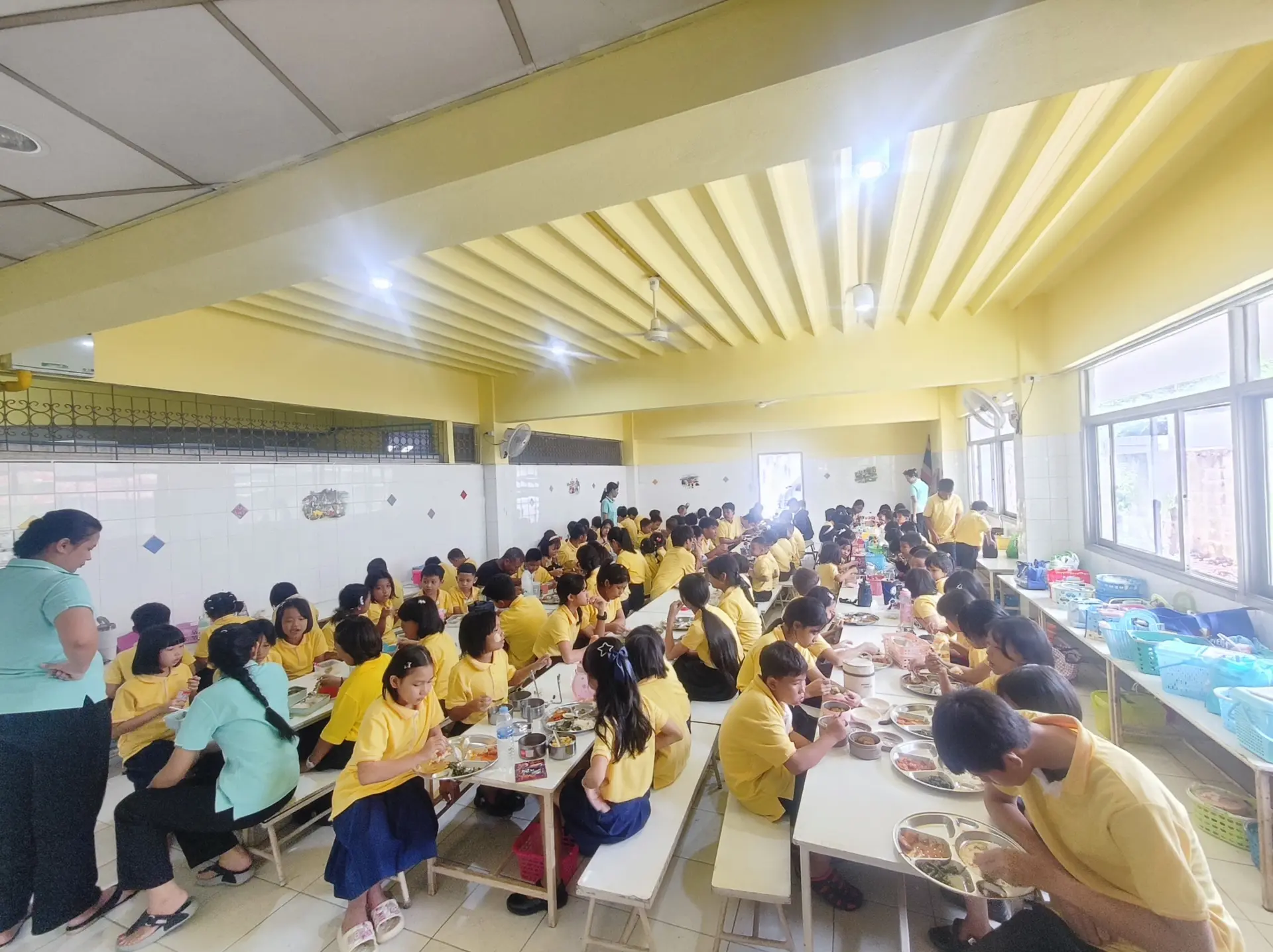 Kong Lah School students sharing a meal in the school dining hall.