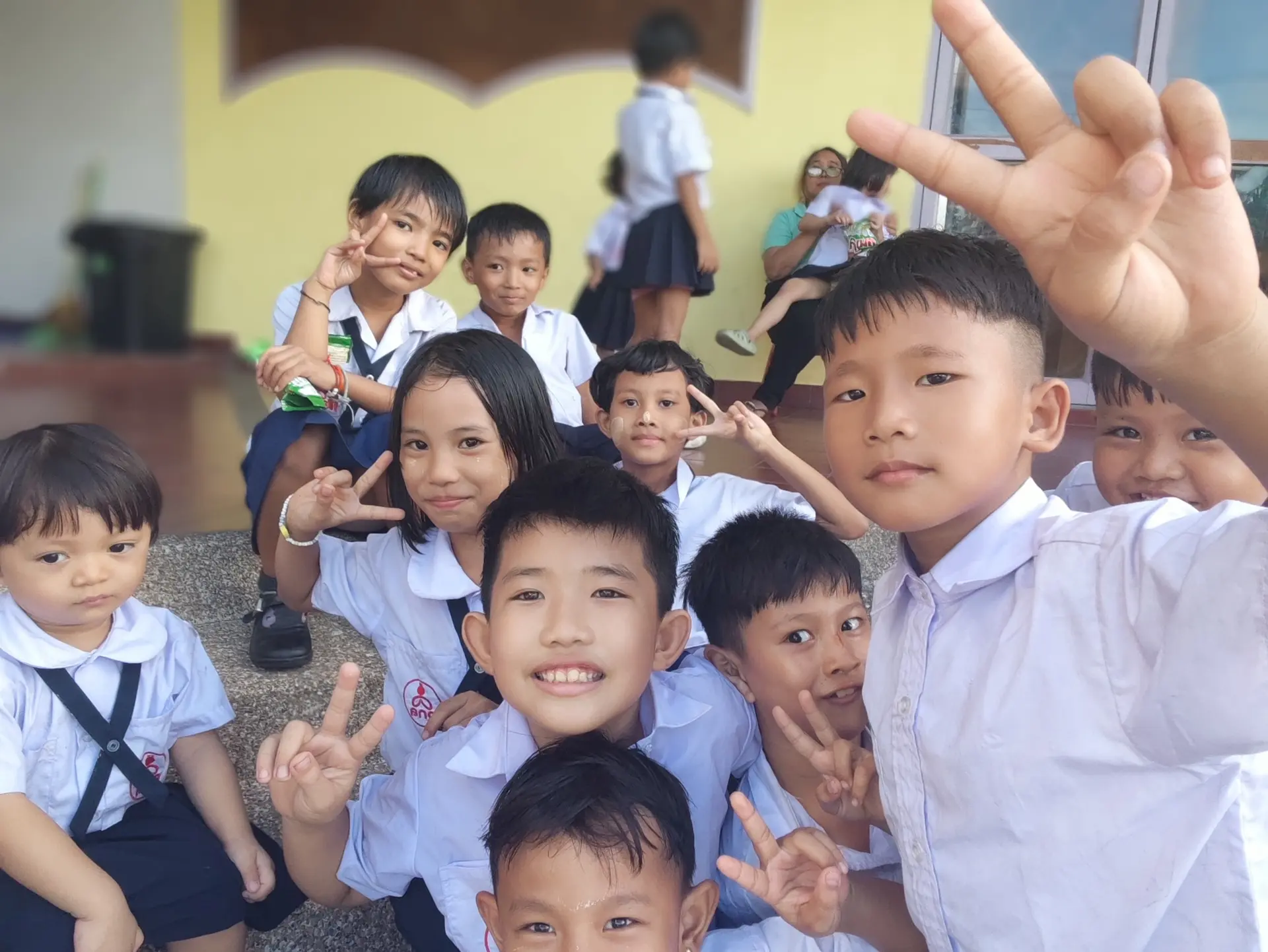 Kong Lah School students smiling together in their school uniforms.